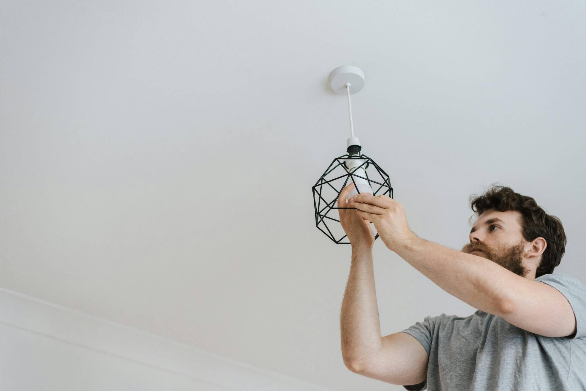 electrician installing pendant light